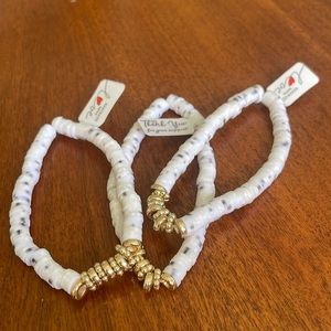 white clay beaded bracelet with gold charms